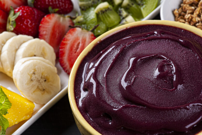 Brazilian açaí in a bowl accompanied by tropical fruits. Fruit of the Amazon